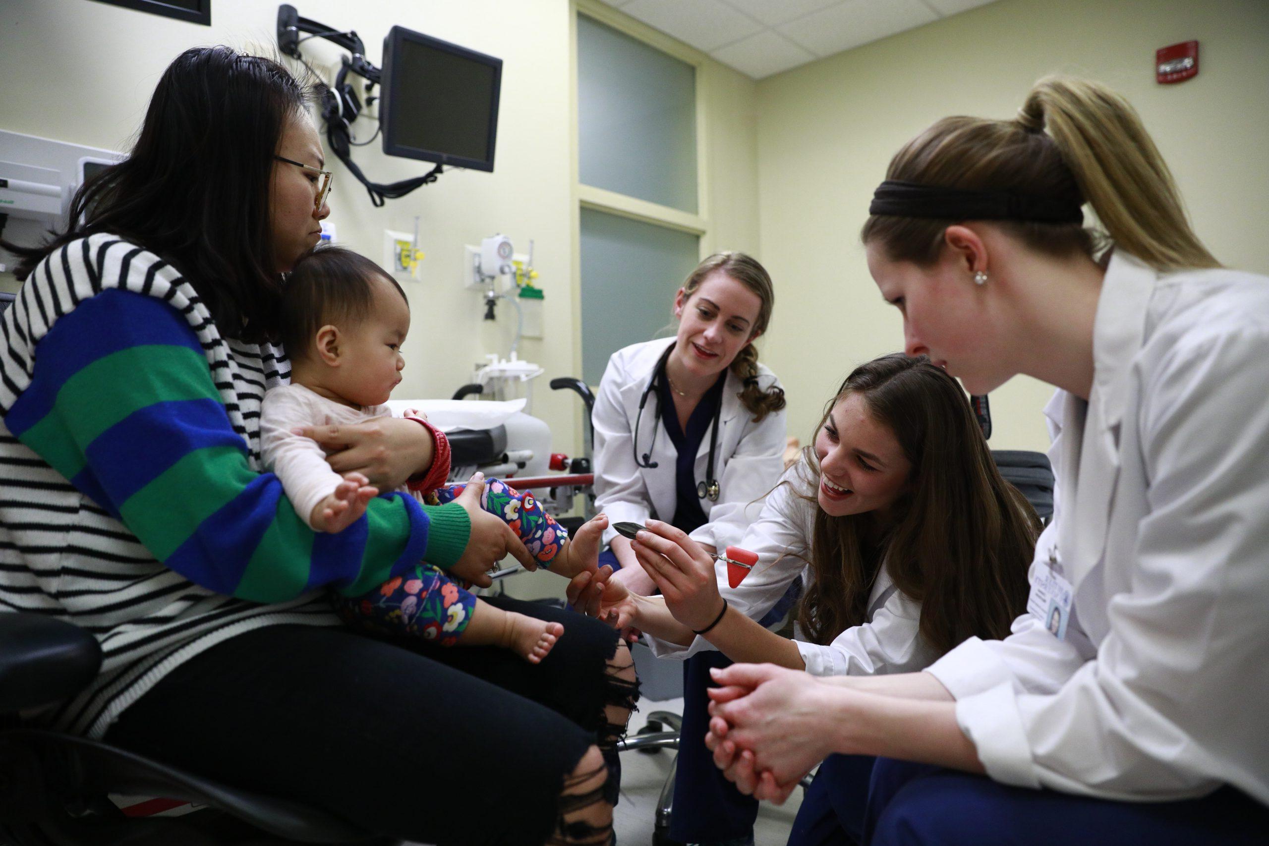 pharmacy students checking out a patient